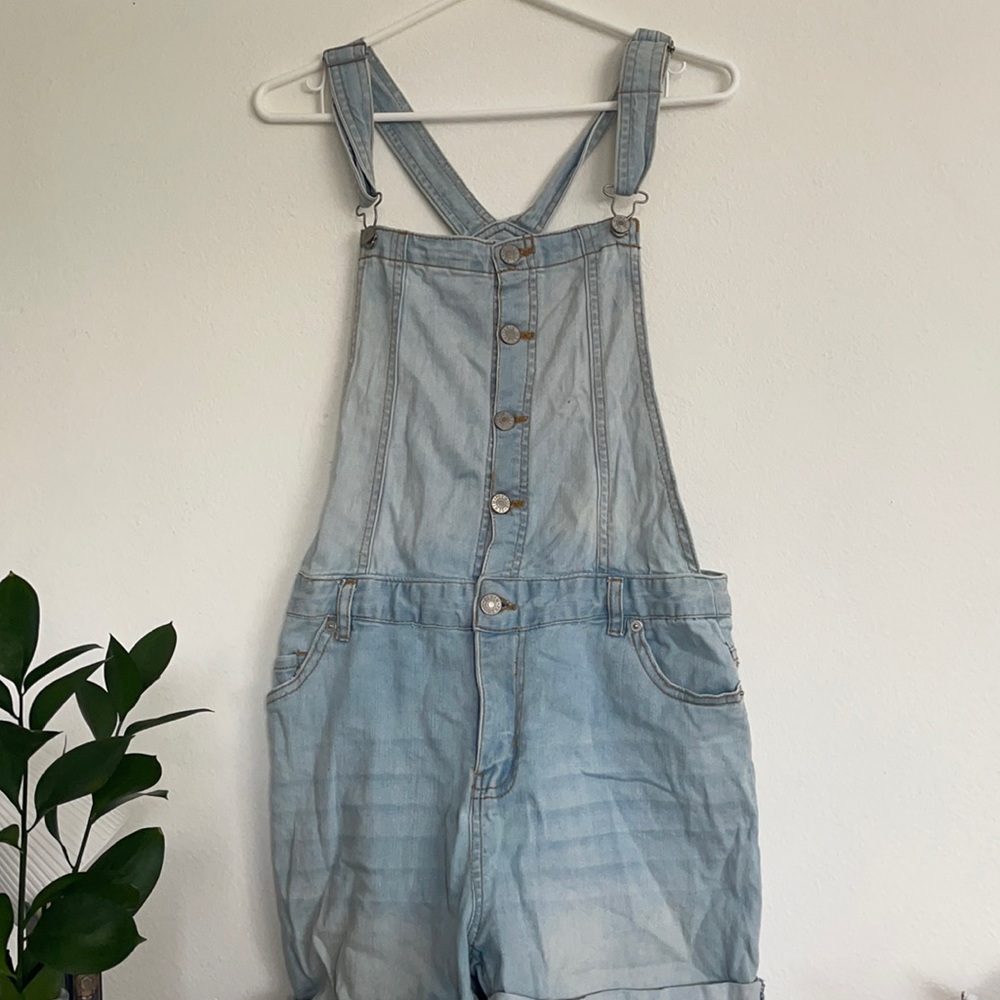 Light wash overall shorts.